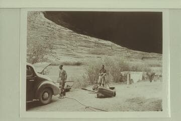 Unloading the punt near Moab at end of traverse of the Dolores River. Pres Walker and Margaret Marston
