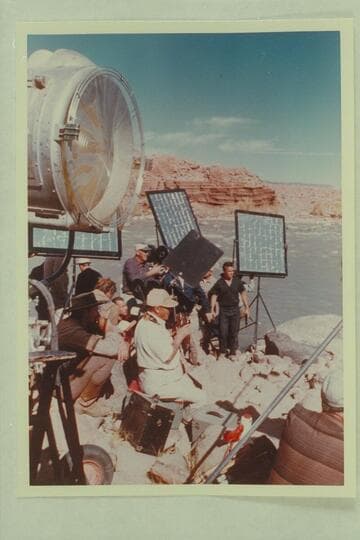 Disney camera crew at Idas Riffle.  Filming of "The Colorado River Story."  Bert Lynch, still camerman sits center.  Bill Beaudeen, director, sights the camera
