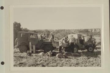 Kent Frost's jeeps en route to the Needles country. Joe Desloge stands with hands in pockets in background. Kent Frost arranges luggage at right. Masland has back to camera at right