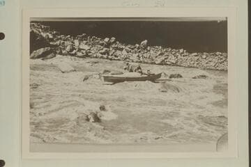 The Kolb brothers at salvage operations in the boat rock-locked in Dark Canyon Rapids.  USGS Cataract Canyon survey under W. R. Chenoweth.  Copy of small print loaned by Chenoweth