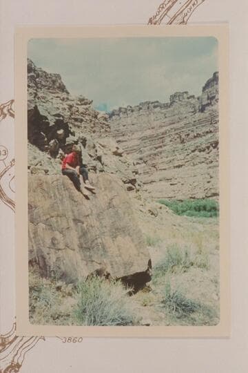 Jody Baker on the boulder which bears the Brown-Stanton inscription. Left bank of the Colorado below the mouth of the Green