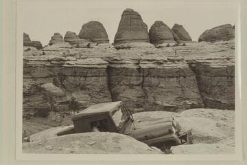 Kent Frost driving his jeep up heavy grade in Needles Country. Margaret Marston rides as passenger. Elephant Creek enters the Colorado at Mile 3.1
