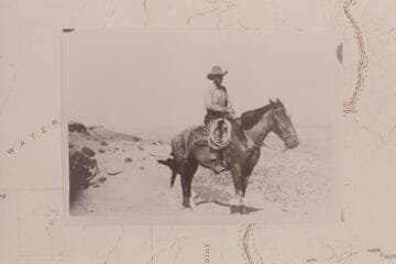 Ned Chaffin mounted on Fox. On Black Ledge above Teapot Canyon which carries the name Calf Canyon on the Quad