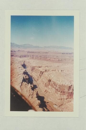 Down river from the end of Mille Crag Bend at Mile 174.5. The mouth of the Dirty Devil and the Henry Mts. in distance
