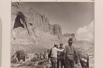 Arch in the Sky. South end of Cummings Mesa. Tom Daly, Bahe, White-hat ready the packs