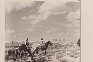 Nancy and Tom Daly stop on the bench on the south end of Cummings Mesa.  Navajo Canyon lies back of them and West Canyon is off to their left hand