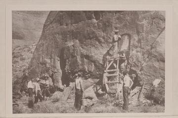 Mason cutting the wall for the plaque at Rainbow Bridge