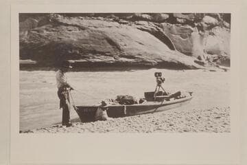 Skiff of Lasky party in small rapid just below Hite; Jesse Lasky, Jr. and Kenneth Wortley