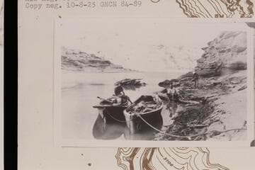The "Canopy" after losing her canopy at Mile 105 1/2.  The skiff "W. H. Bradley" is at right.  Near Hole in the Rock.  Between Aug. 25 and 28, 1910