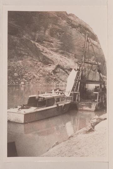 The drill barge at Glen Canyon Damsite. The Higgins boat was used to carry freight up from Lees Ferry