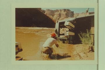 The "Kitty" rolled for repairs above Soap Creek Rapid. She sprang some inner plies when landing. Frank LaRue is the photographer