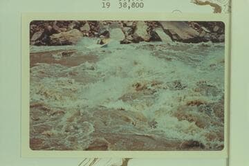 The "Wee Yellow" down Soap Creek Rapid. Bill Austin runs down after topping the rapid on a test run. Dock Marston was a passenger
