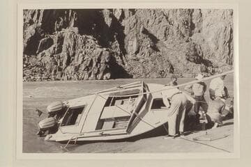 Repairs to "Cactus", Travertine Canyon.  Desloge looks into the hatch, Cutler is amused, Bundy watches Sanderson at work and Richey carries a load of dunnage