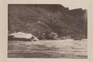 One of the Nevills boats dropping into Paria Riffle. Old Mormon Dugway on left bank