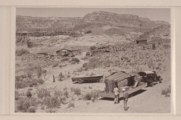 Boats and motors arriving at Lees Ferry for the start of the Marble-Grand Canyon traverse. The buildings in the background are those in use by the USGS for the river gauging