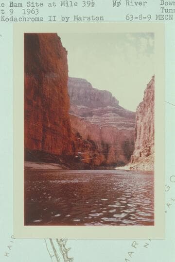 Lynn Roberts' helicopter and the air line suspended on a cable at the Dam site at Mile 39 1/2.  Downriver.  Tunnel  dum[p] at left