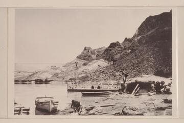 The heavy boats of the Eddy Expedition being overhauled at Lees Ferry. The "Powell" shows at left. The "Coronado" is center and the "Dellenbaugh" is on the beach. Copied from Carey collection