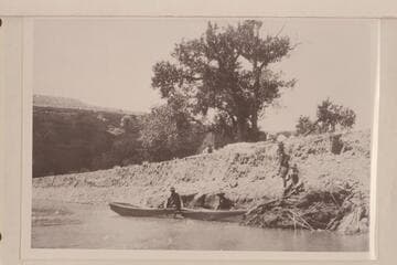 Four miles southwest of Bluff, Utah, where boats were launched 1921, July 18.  Low cliff on top part of Navajo sandstone next to river.  Taken just after launching boats.  The boats were simple open skiffs