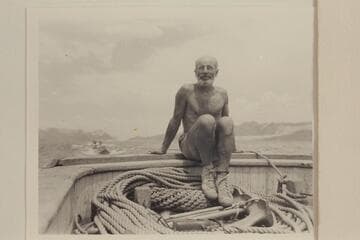 Dock Marston on the stern of the motorboat towing the Nevills sadirons down Lake Mead