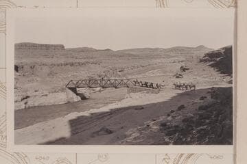Spencer pack outfit at the bridge across the San Juan River below Mexican Hat. C. H. Spencer leading on his horse "Chunk." He remarked at the time that it was the first time in his many crossings of the San Juan that he felt safe