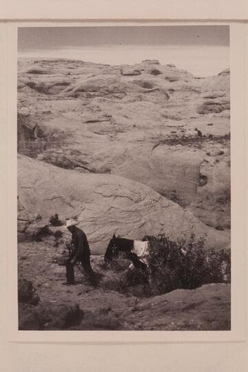 Bill Belknap leads his horse out the slickrock trail west of Nasja Creek