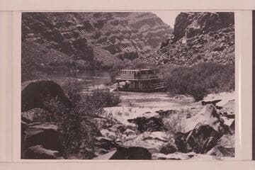 The "City of Moab" tied to bank below The Slide on the Grand River after failing to negotiate this rapid in 1905, May
