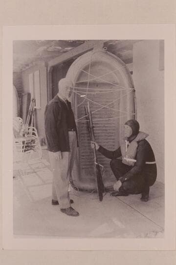 Dock Marston and Bill Belknap with Sportyak used in 1964 transit of Cataract Canyon.  News photo with Polaroid camera