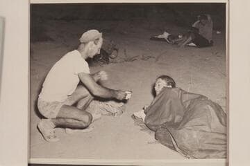 Norm Nevills serves coffee to Anne Desloge for the benefit of Bureau of Reclamation photographer William S. Russell. End of 1947 Traverse of Grand Canyon at Pierces Ferry