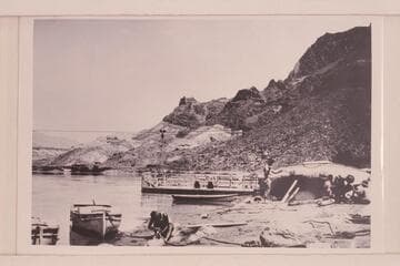 The heavy boats of the Eddy Expedition being overhauled at Lees Ferry 1927, July 13. The "Powell" shows on the left. The "Coronado" is center and the "Dellenbaugh" is on the beach