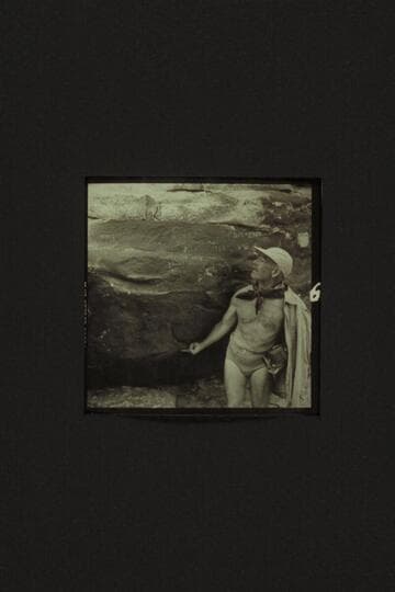 Marston standing on ledge and examining the inscription where Frank Mason Brown was drowned in 1889. Mile 12, Marble Canyon