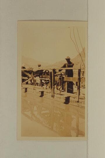 Checking the outboard motors from Lees Ferry.  Tom Wimmer at right.  Before the start up Glen Canyon to meet the LaRue party at Hall Creek.  Print from Freeman collection