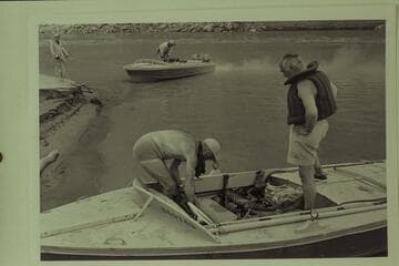 Preparation for the departure from Lees Ferry.  Masland supervises the stowage by Marston.  Cutler holds the bow line for Sanderson