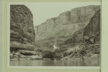 The pile of drift on top of the boulder at Boulder Narrows burning after ignition by the 1940 Nevills party.  Lees Ferry gauge:  2m600 cfs