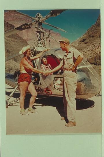The helicopter on the beach at Tapeats Creek.  Left to right:  Dock Marston, Margaret Marston and Red Carson