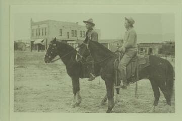 Probably near the old Metropole Hotel, Green River. Pat Brown at left and Kendrick Levi.  Their activity was prospecting for oil in the Green River-Hanksville section