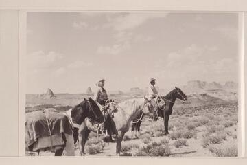 Nancy and Tom Daly stop on the bench at the south end of Cummings Mesa.  Navajo Canyon lies back of them