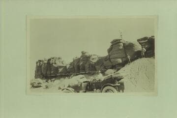 The Zahn's [sic] Franklin car in front of some salmon-colored sandstone formations near Tuba City.  The car was taken from Los Angeles to the Zahn Mine on the lower San Juan River