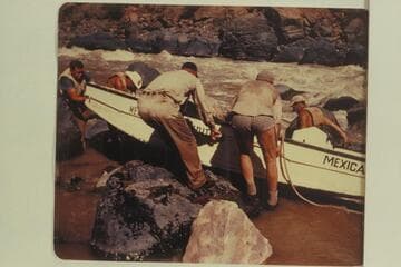 Portage of "Mexican Hat II."  John Harper at the bow; Duane Bishop and Willard Wright on far side.  Frank Wright and Bill Thompson on near side.  Georgie White ran her party through the rapid the same day