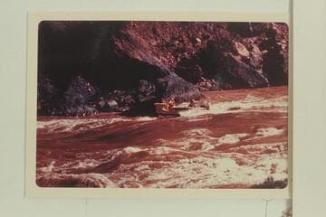 The Deck-Boat starting into Vulcan Rapid. Jim-Bob Rowlands is at the wheel. Dock Marston is piloting. Jim Jordan and Shell Wimpfen sit aft