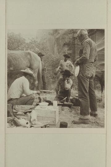 Breakfast at camp at head of middle fork of 73. Tom Daly and Buster Ordiway on the ground. Archeyes Masland looks hungry. Nasja Begay and Dan Leho in background