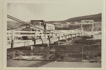 A truckload of uranium ore crossing the bridge at Mexican Hat. The obvious strain on the structure broke it and the bridge was replaced