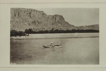 The boat of the LaRue - Richardson - Wimmer Glen Canyon trip of 1915 which traveled from Hite to Lees Ferry between August 25th and 29th. . . . From the left bank opposite Tickaboo Canyon 23 miles belos Dirty Devils River. . . . Probably mile 146.8