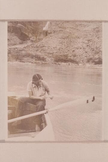 Anne Desloge cleaning fish. The boat is moored at the beach below Tapeats Creek
