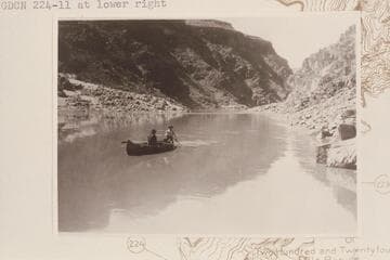 McCuish at the oars with Wilbur steering with a paddle in a folding boat used in prospecting the lower Grand Canyon