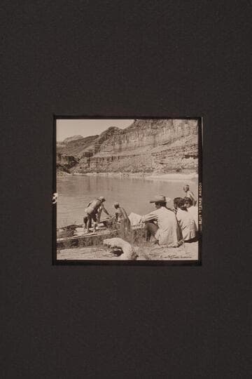 Stowing dunnage on the "Bootoo" at Whitmore Wash. Marston standing on the boat hides Masland, Argwen Bundy hands dunnage aboard, Hughes and his wife Ila May, watch the proceedings and Joe Eisaman stands at right