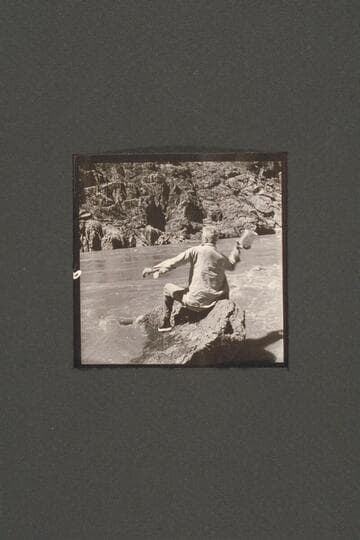 Joe Desloge carries on various activities during the repair of the "Cactus" below Tuna Creek Rapid.  Here he heaves an empty can into the "treacherous river"