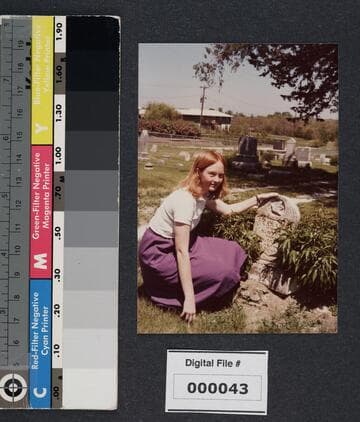 Sarah Babcock kneeling next to tombstone of Sarah Otis