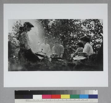 Edwin Powell Hubble and five unidentified companions seated around a campfire