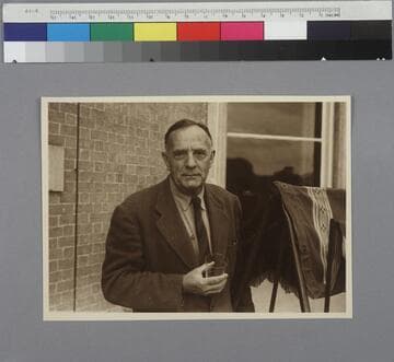 Edwin Powell Hubble standing outside of Bossington House in Hampshire, England