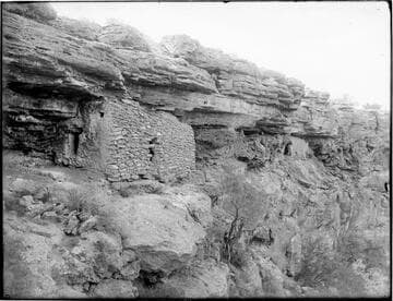 Rock face with rock structure built against it